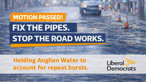 Campaign graphic reading “Motion Passed! Fix the pipes. Stop the road works.” with the line “Holding Anglian Water to account for repeat bursts,” over a blurred flooded street background.
