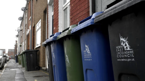 Recycling and household waste bins outside homes in North East Lincolnshire.