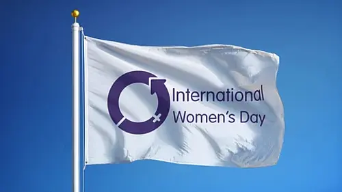 International Women’s Day flag, representing the recognition of women’s achievements and inequalities affecting women and girls.