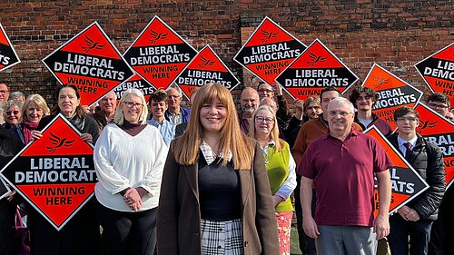 Group of Liberal Democrat campaigners in North East Lincolnshire holding “Winning Here” signs during local election 2026 campaign