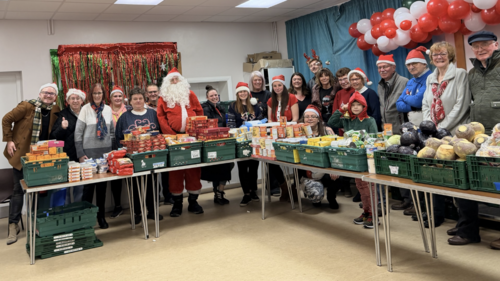 Photo of Liberal Democrat councillors and volunteers at Feed the Community Foodbank on Convamore Road, helping sort donations and support local families.